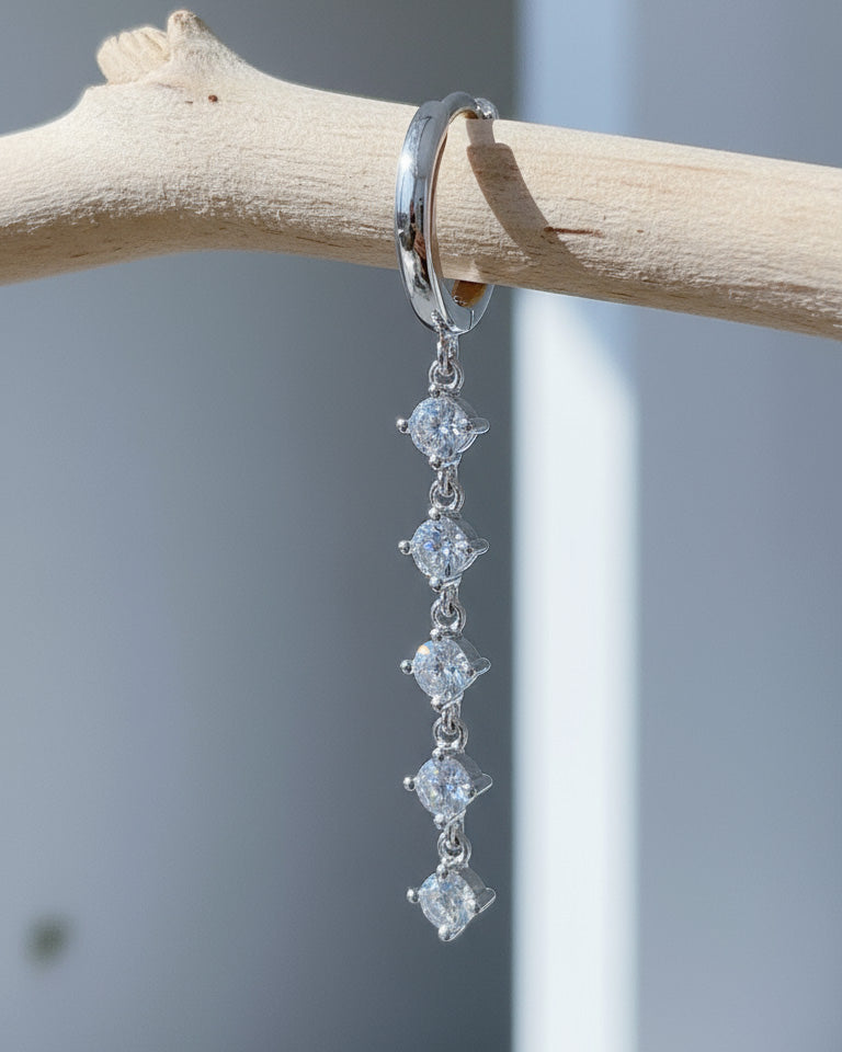 plain huggie hoop with five dangling white CZ.