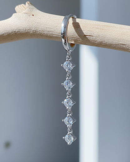 plain huggie hoop with five dangling white CZ.