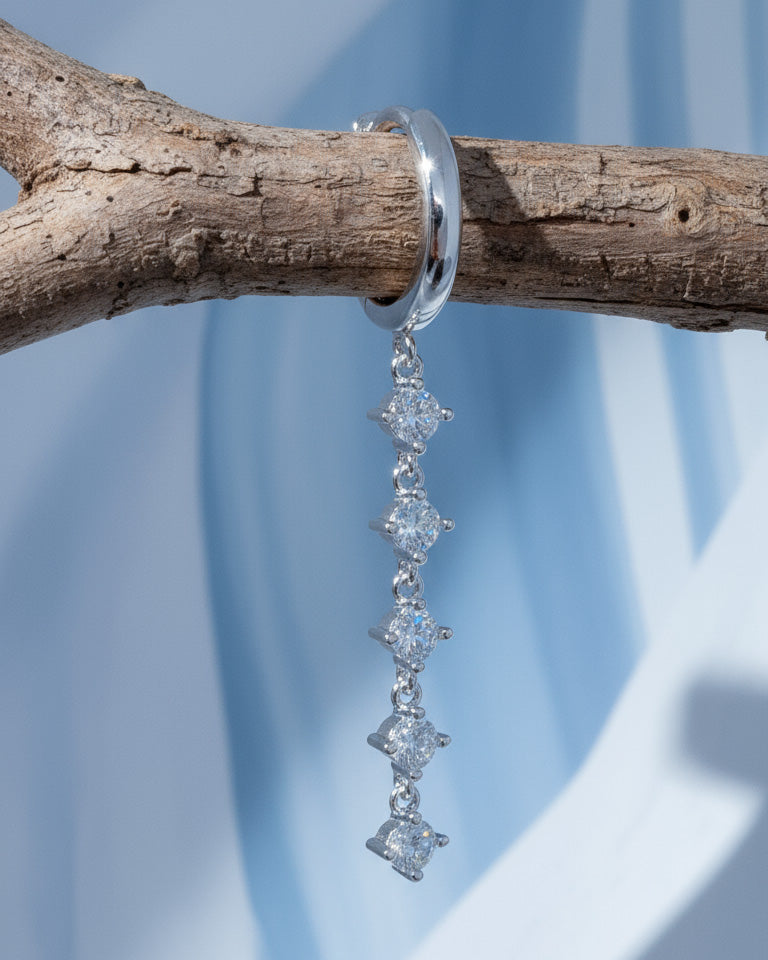 plain huggie hoop with five dangling white CZ.