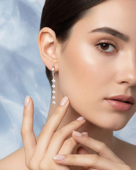 plain huggie hoop with five dangling white CZ.