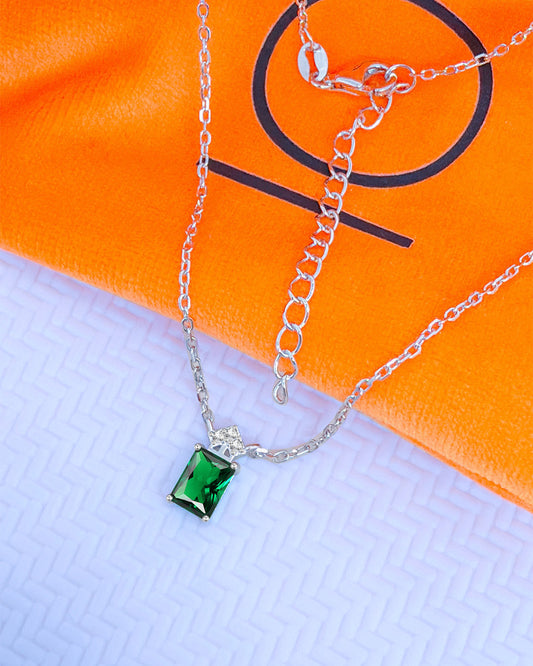emerlad cut green CZ stone with three white stones neckace.