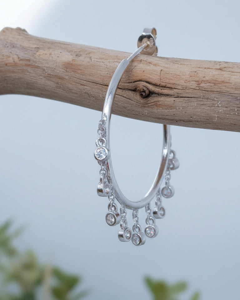 Plain hoops with dangling CZ in bezel setting.