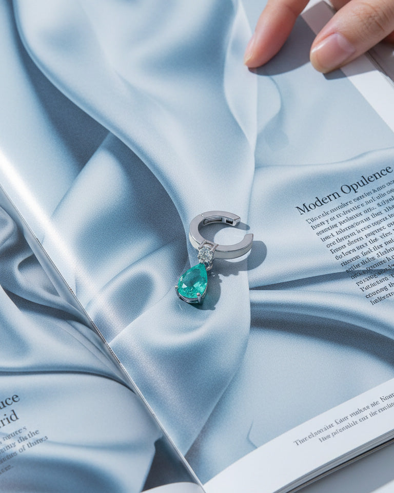 white enamel ear-cuff with dangling green pear shape CZ stone.
