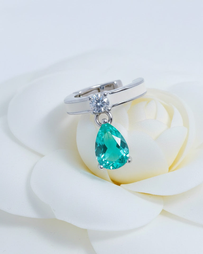 white enamel ear-cuff with dangling green pear shape CZ stone.