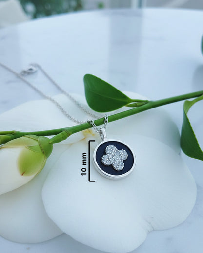 four clover flower CZ in a black enamel round shape necklace.