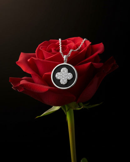 four clover flower CZ in a black enamel round shape necklace.