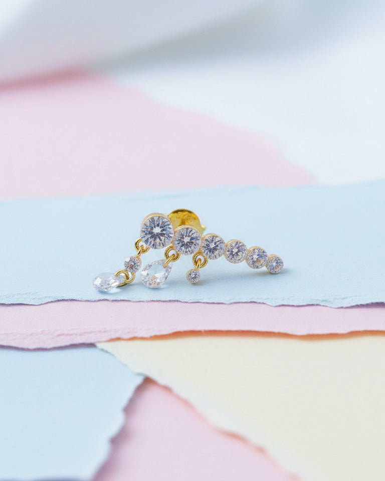 Round graduated CZ bar with dangling pierced pear shapes.