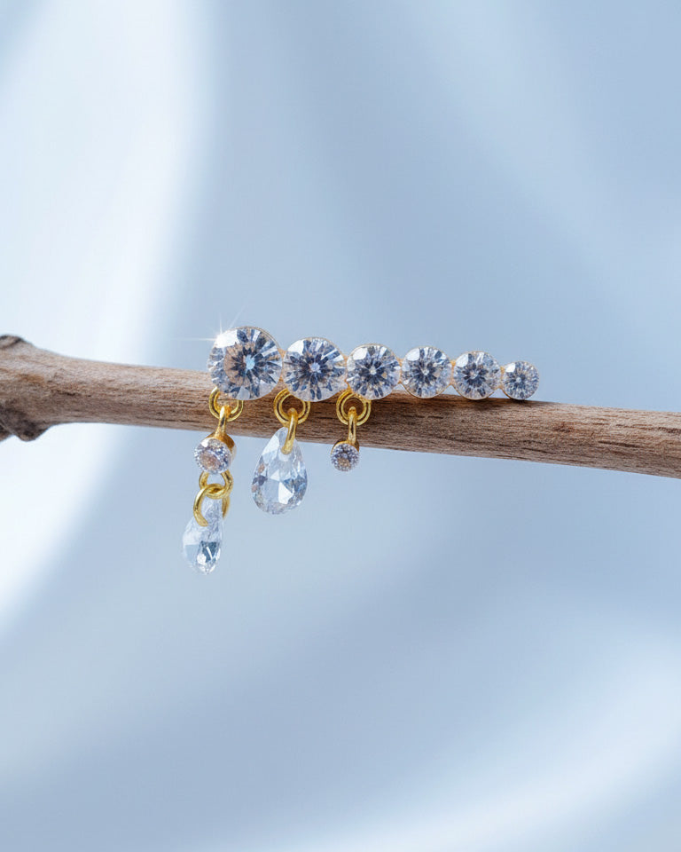 Round graduated CZ bar with dangling pierced pear shapes.