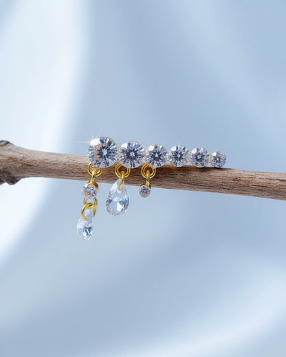 Round graduated CZ bar with dangling pierced pear shapes.