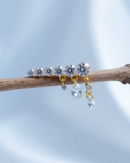 Round graduated CZ bar with dangling pierced pear shapes.