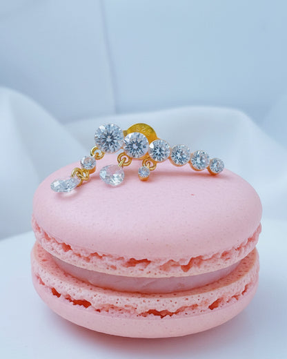 Round graduated CZ bar with dangling pierced pear shapes.