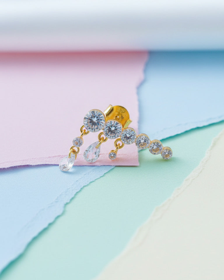 Round graduated CZ bar with dangling pierced pear shapes.