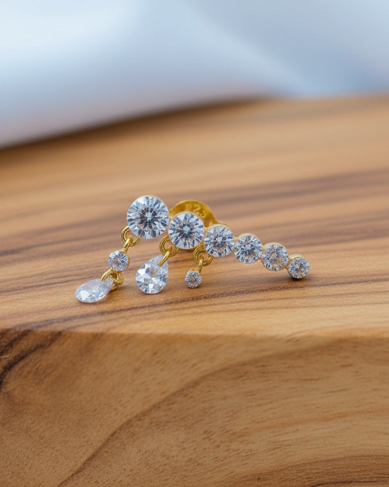 Round graduated CZ bar with dangling pierced pear shapes.