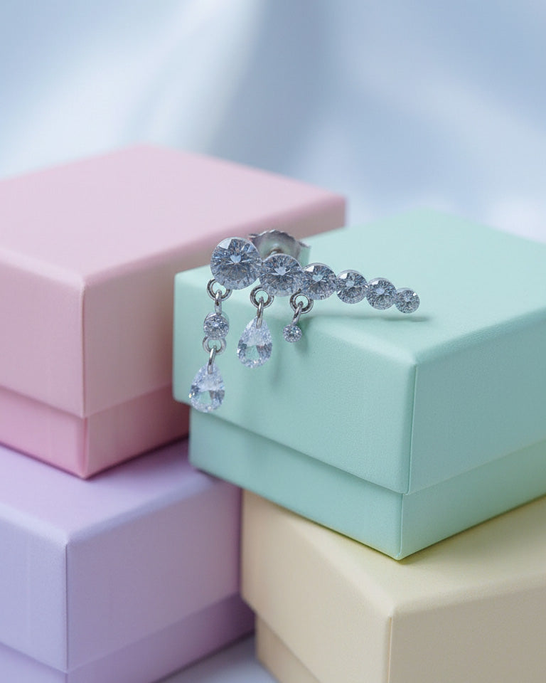 Round graduated CZ bar with dangling pierced pear shapes.