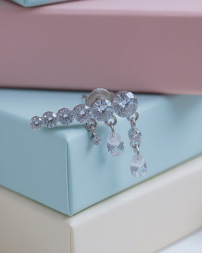 Round graduated CZ bar with dangling pierced pear shapes.