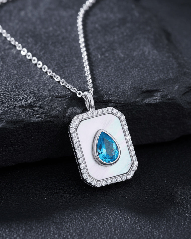 rectangular MOP necklace with pear shape aquamarine color CZ stone.
