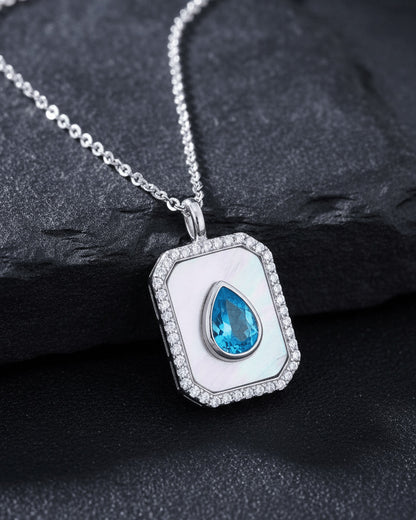 rectangular MOP necklace with pear shape aquamarine color CZ stone.