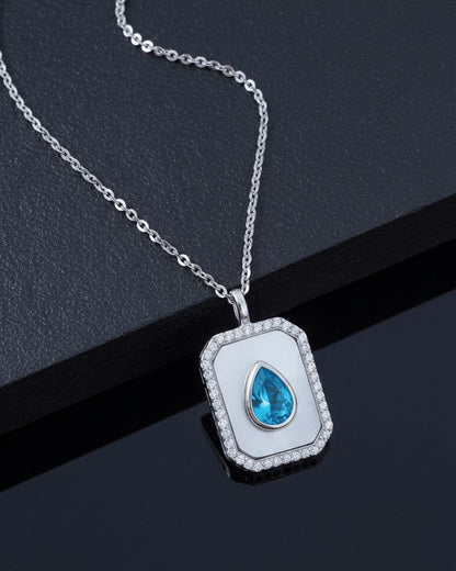 rectangular MOP necklace with pear shape aquamarine color CZ stone.