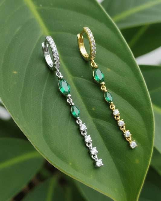 dangling line with two emerald marquise stones hoop.