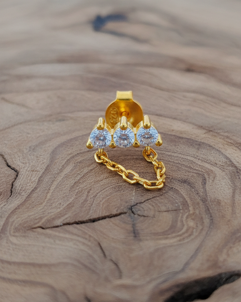 three stones bar earring with dangling chain.