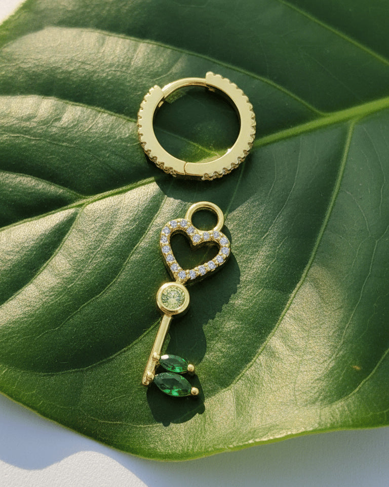 heart key shape dangling huggie hoop earring.