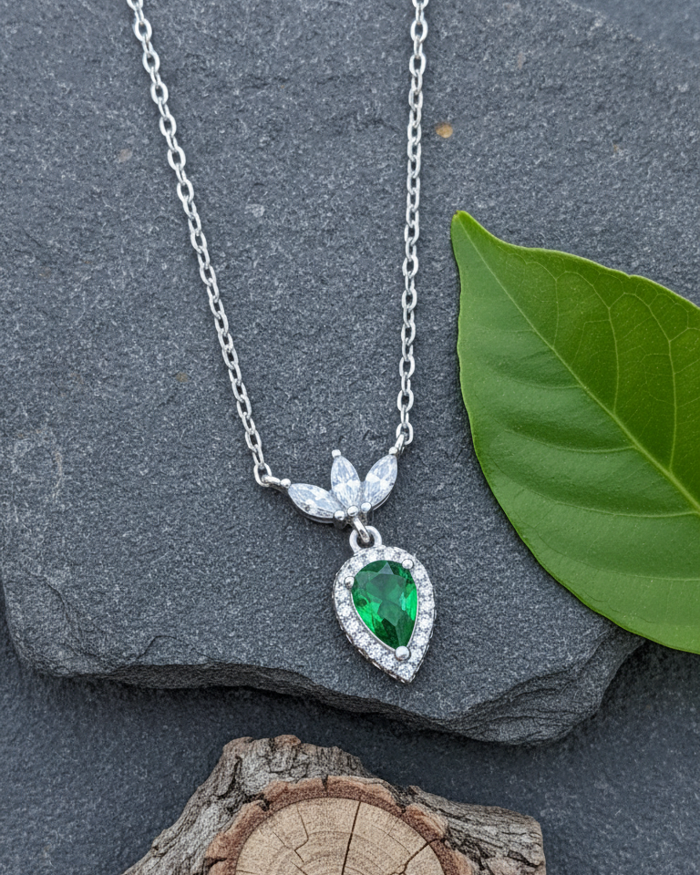 Emerald color pear shape with three white marquise shapes necklace.