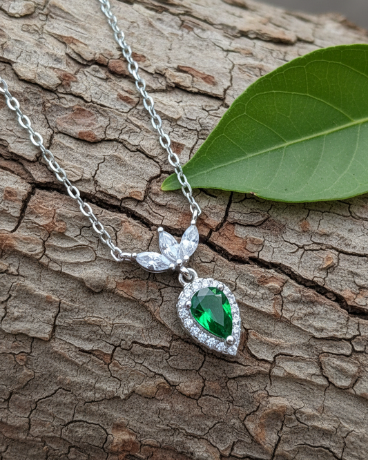 Emerald color pear shape with three white marquise shapes necklace.