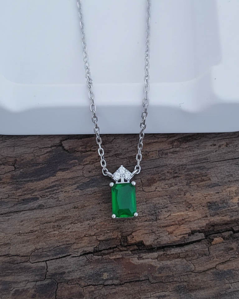 emerlad cut green CZ stone with three white stones neckace.