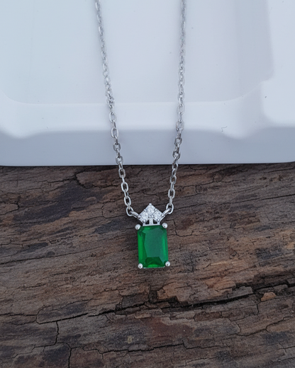 emerlad cut green CZ stone with three white stones neckace.