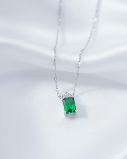 emerlad cut green CZ stone with three white stones neckace.