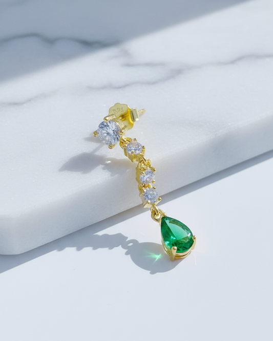 white CZ line ending with emerald color pear shape stud earring.