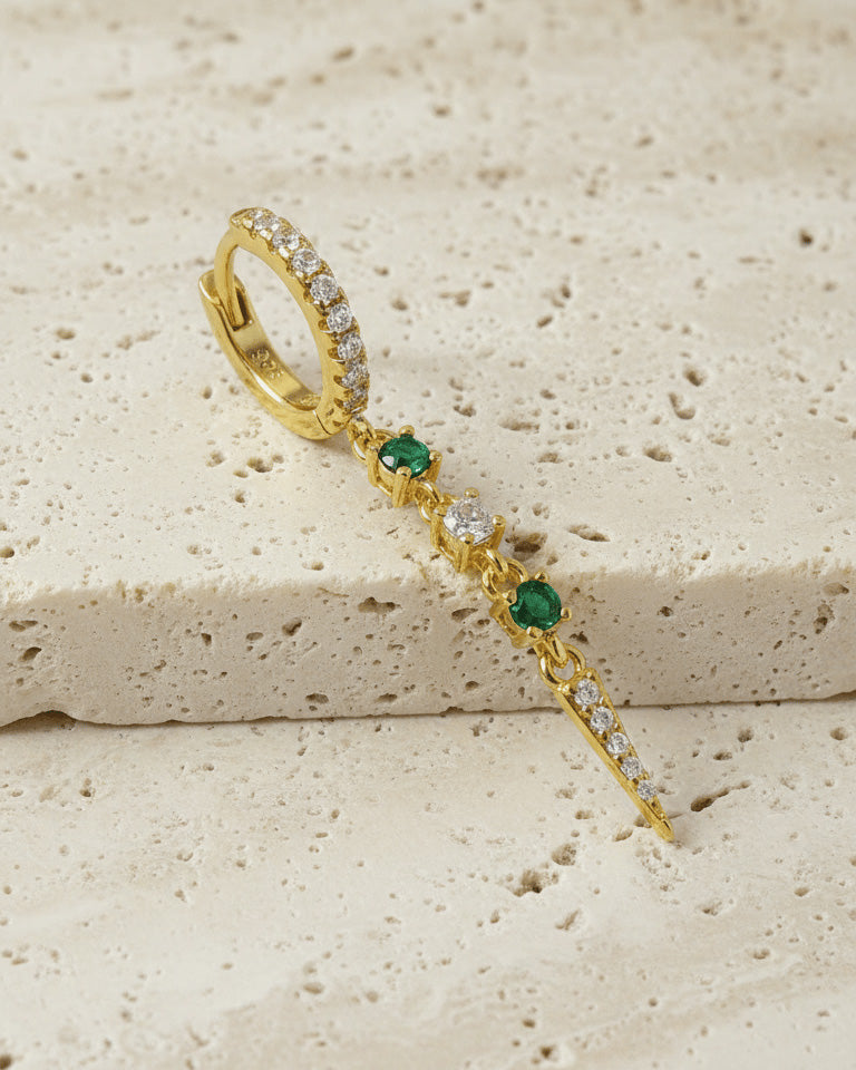CZ huggie hoop with dangling emerald color and white stones.