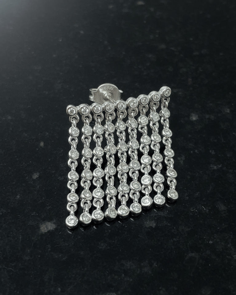 dangling lines of round stones in bezel setting stud earring.