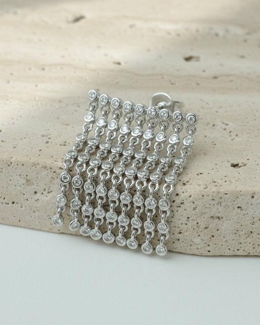 dangling lines of round stones in bezel setting stud earring.