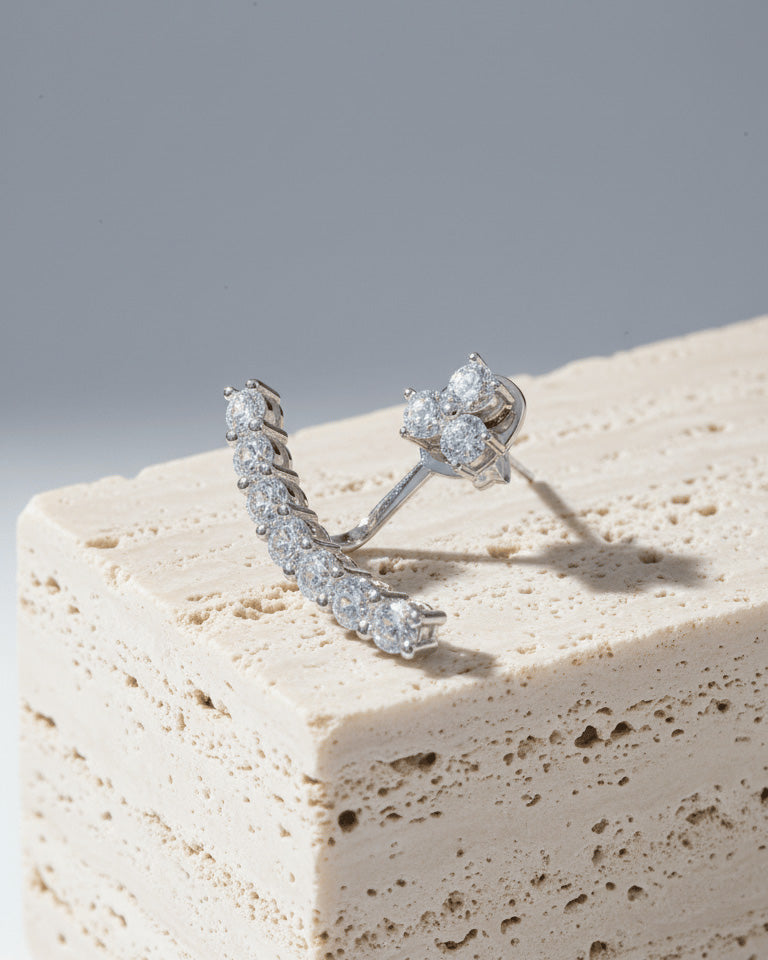 back to front curved line of round CZ stones in prong setting.