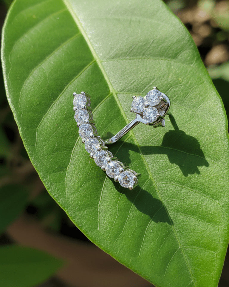 back to front curved line of round CZ stones in prong setting.