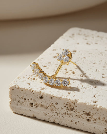 back to front curved line of round CZ stones in prong setting.