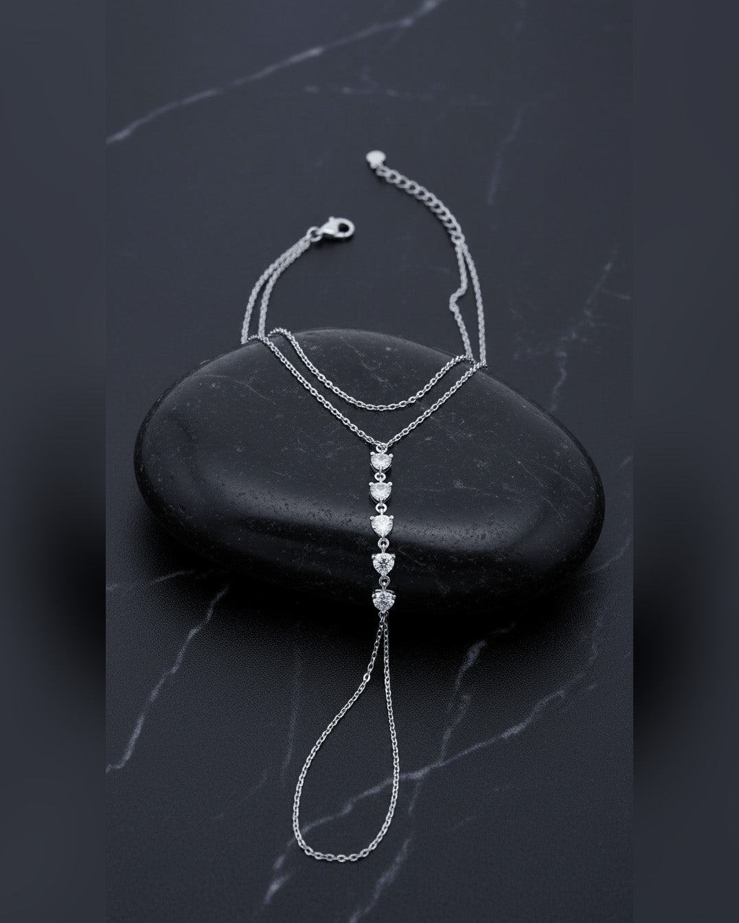 Delicate chain handpiece of five round CZ stones.
