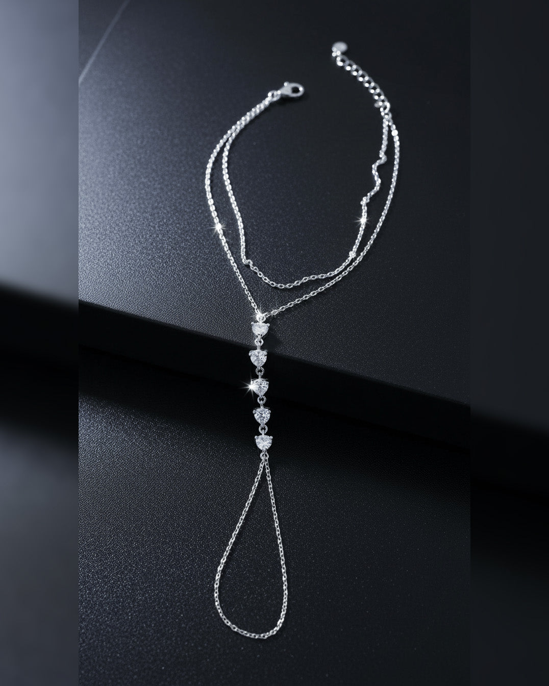 Delicate chain handpiece of five round CZ stones.