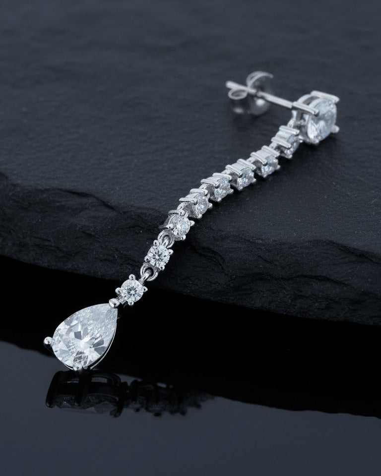 elegant line of round CZ stones ending with a pear shape stud earring.