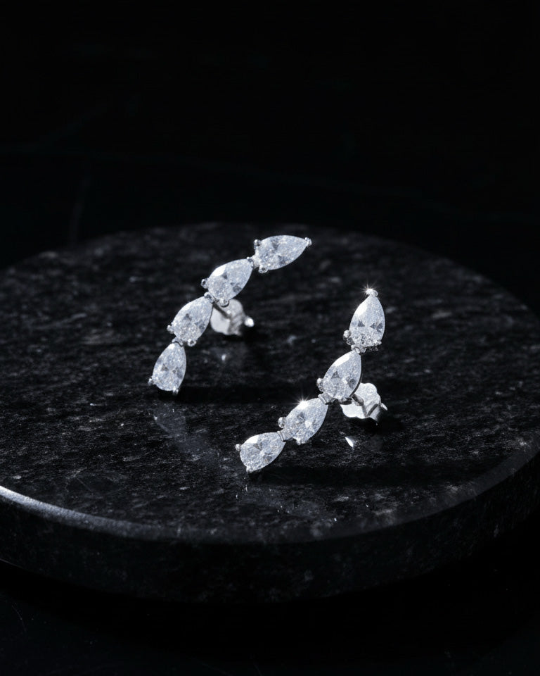 curved bar of four pear shape stones stud earring.