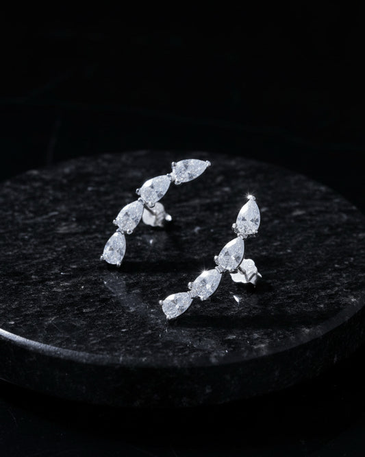 curved bar of four pear shape stones stud earring.