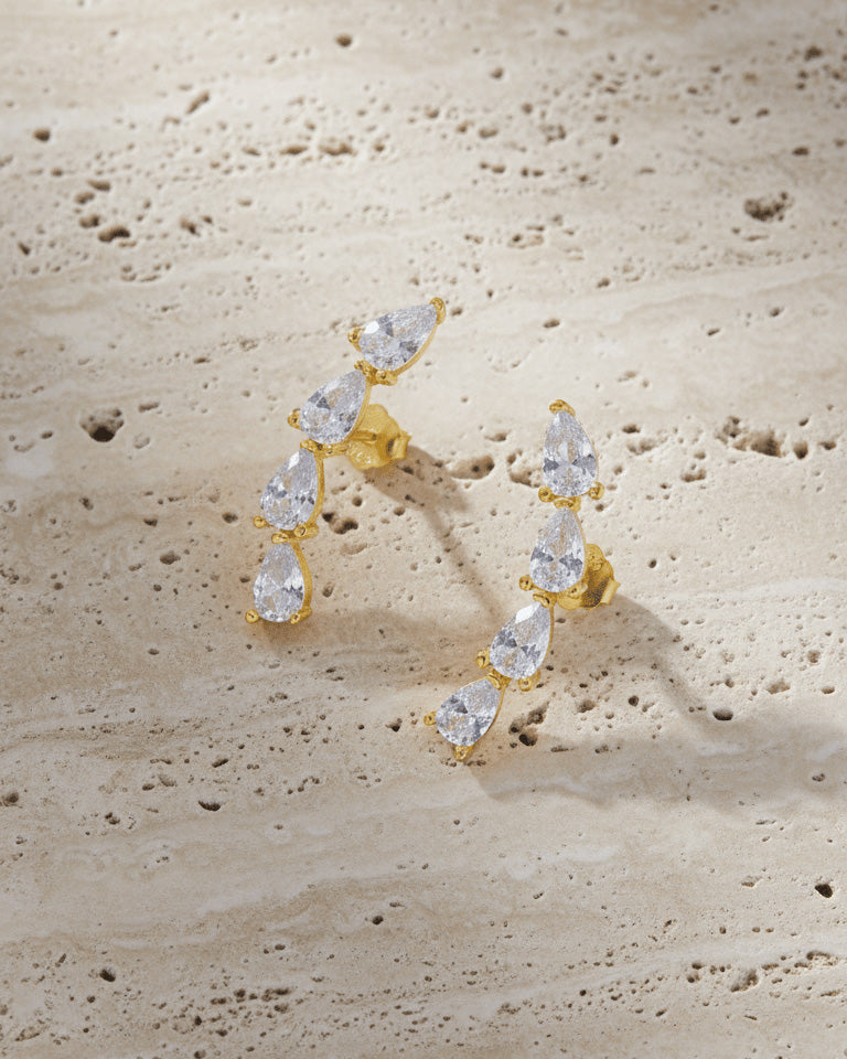 curved bar of four pear shape stones stud earring.