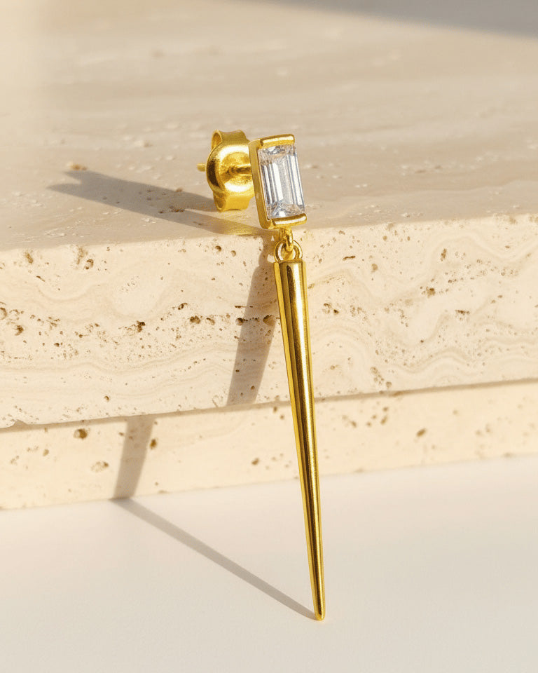 Baguette stone stud earring with dangling cone shape.