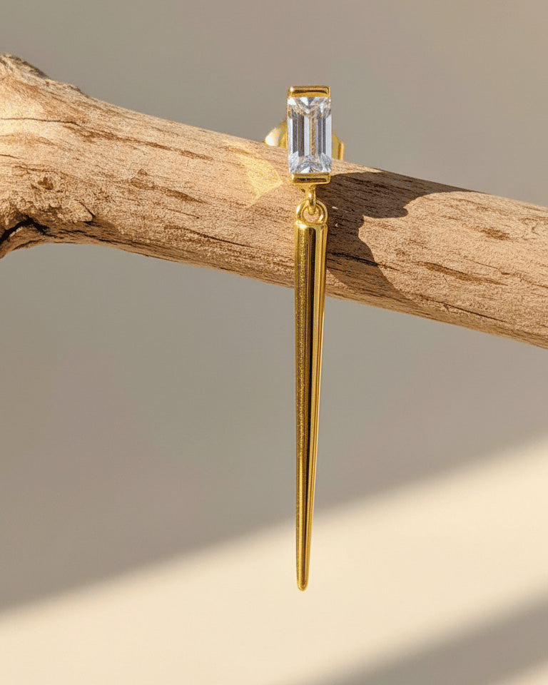 Baguette stone stud earring with dangling cone shape.