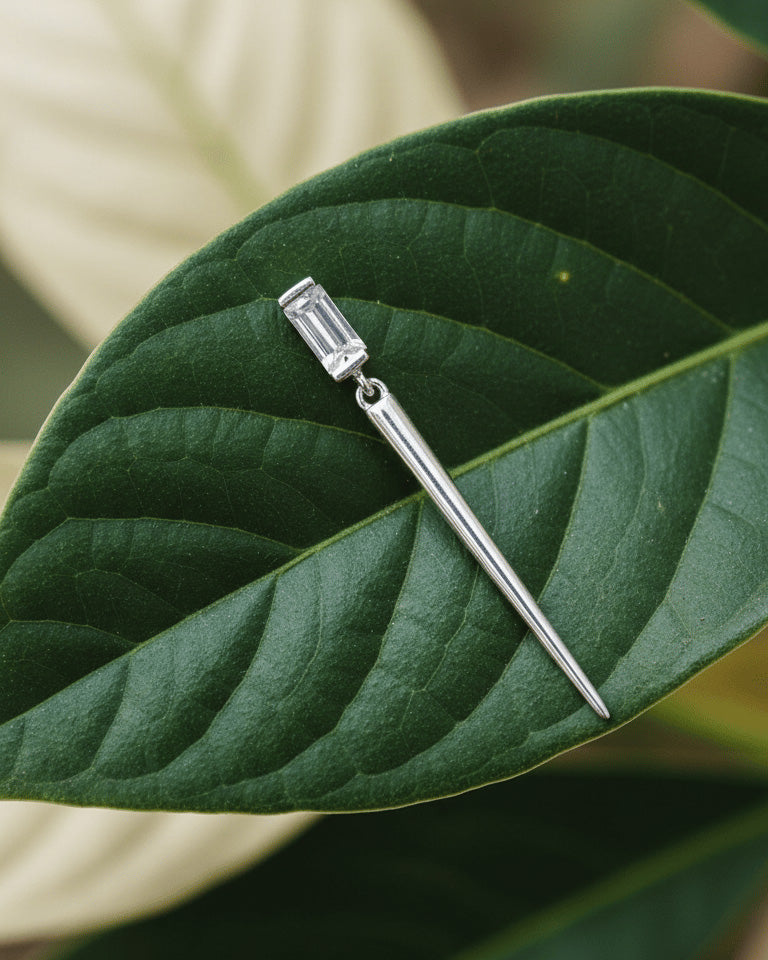 Baguette stone stud earring with dangling cone shape.