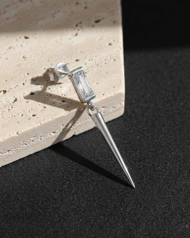 Baguette stone stud earring with dangling cone shape.