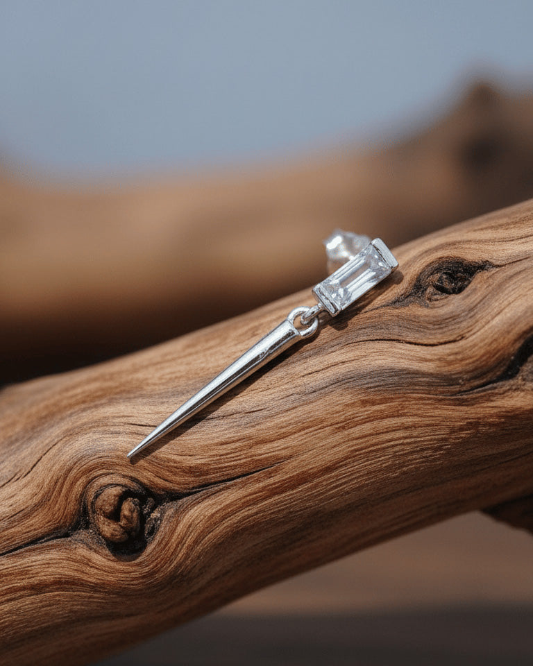 Baguette stone stud earring with dangling cone shape.