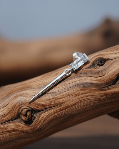 Baguette stone stud earring with dangling cone shape.