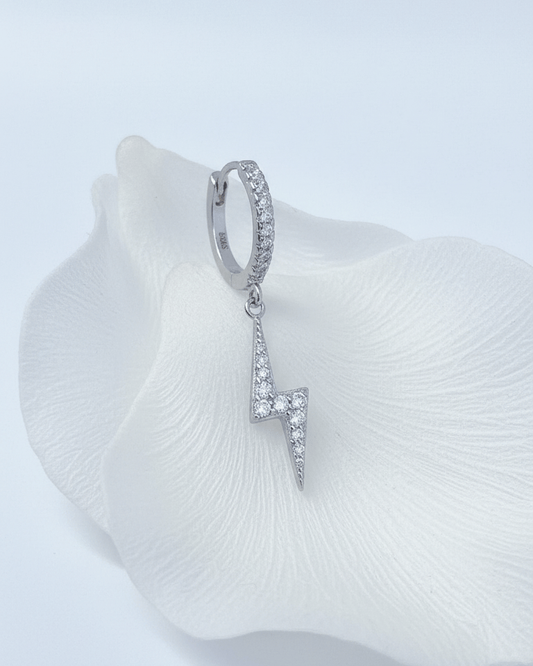 dangling bolt sign hoop earring.